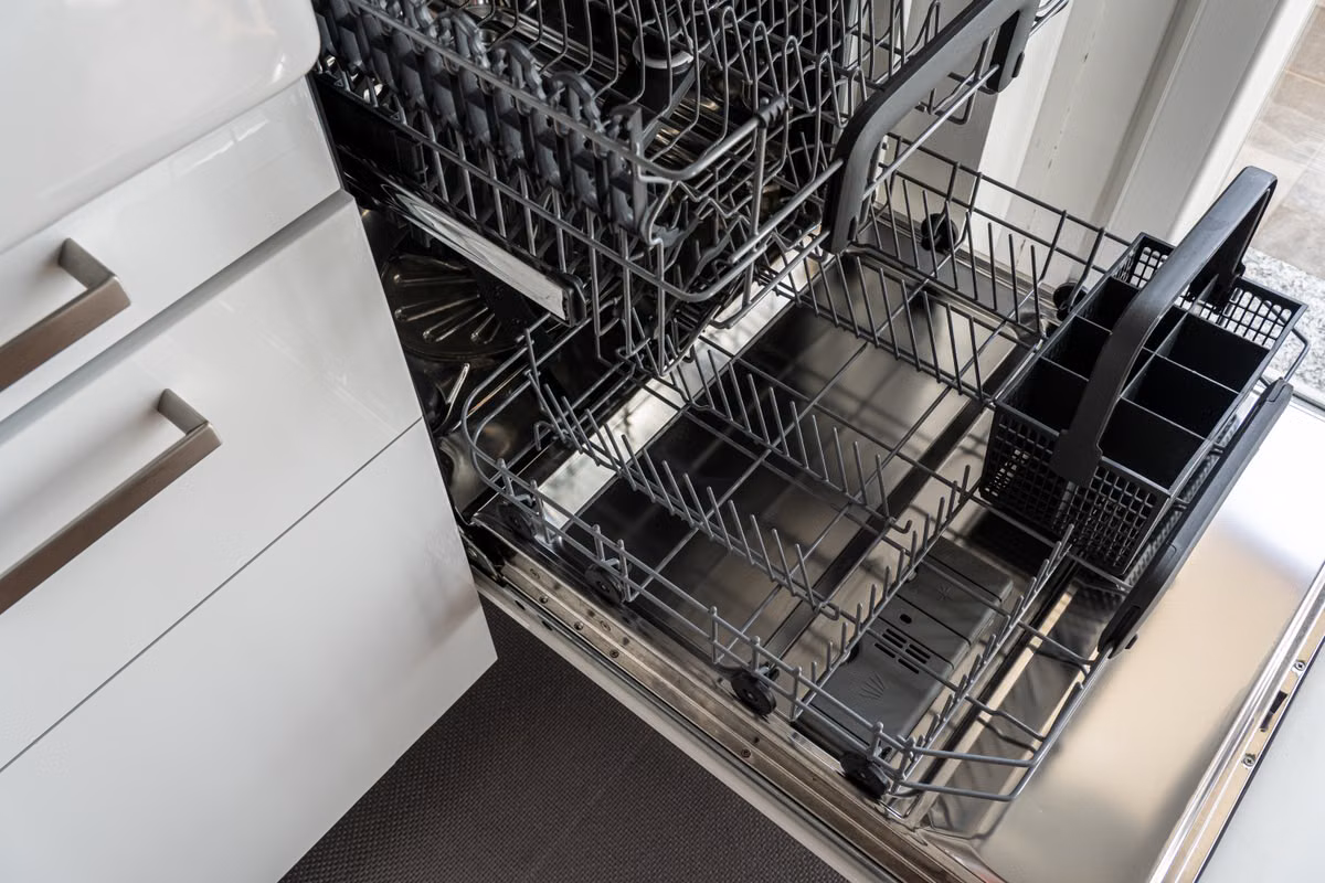 Appliance Matters technician servicing a built-in dishwasher in a Calgary kitchen