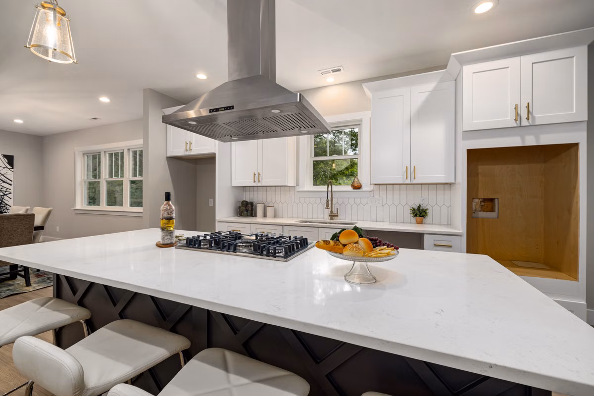 Appliance Matters technician repairing a stainless steel range hood in a Calgary kitchen